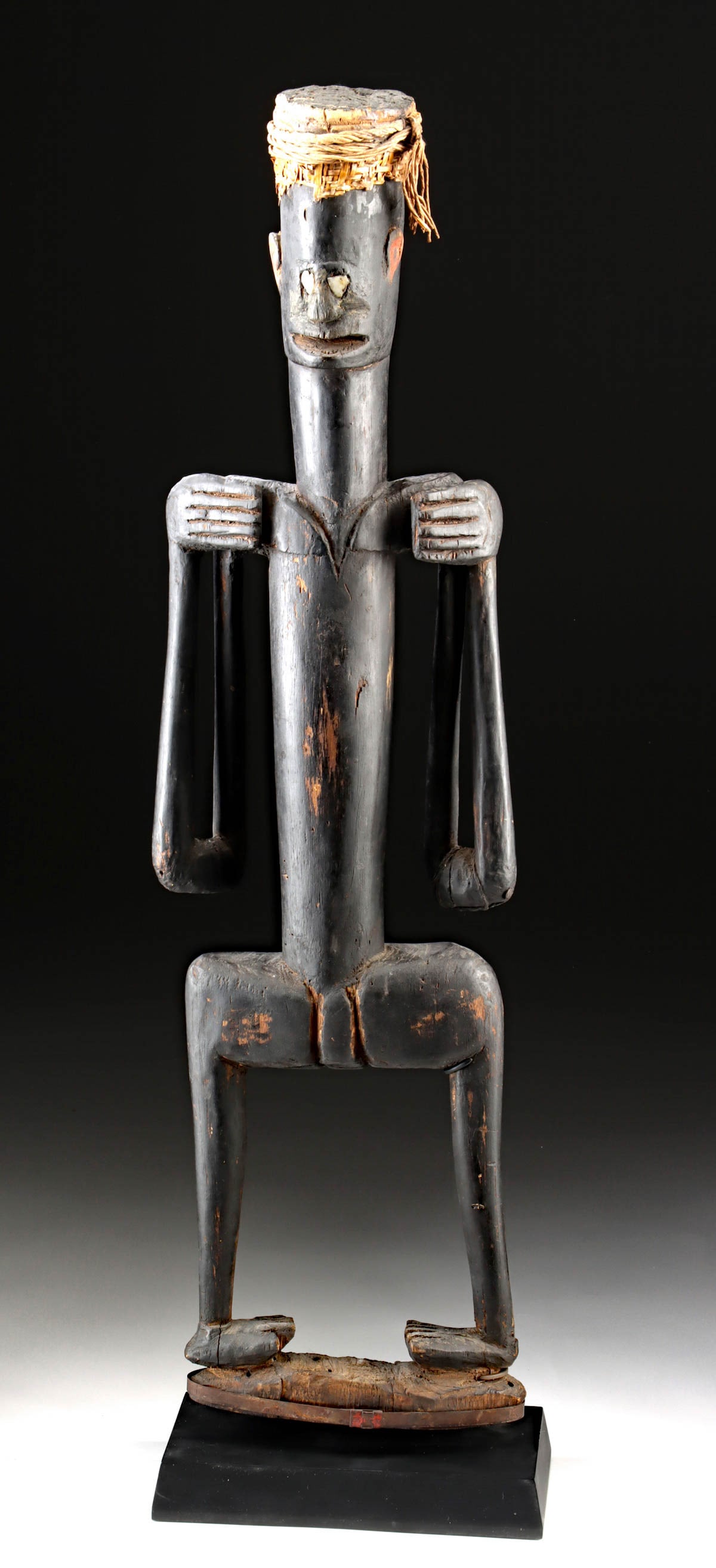 Buka Island Male Ancestor Figure, Inlaid Shell Eyes and Headdress: Oceania, Melanesia, Solomon Islands, Buka Island, ca. 19th to early 20th century CE. A rare carved male ancestor figure from Buka Island in the Solomon Islands, rendered in darkened wood with characte