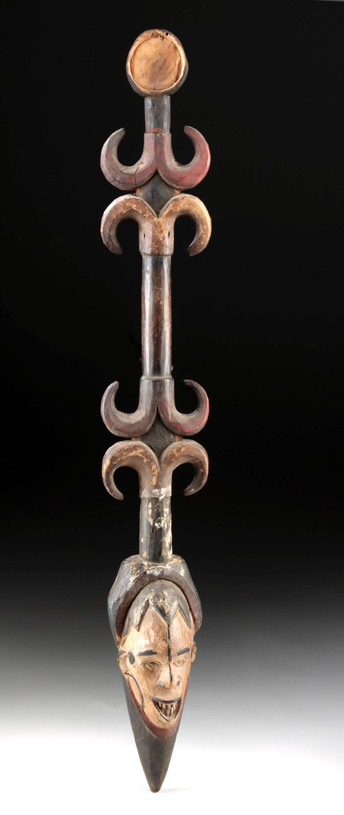 1880s Nigerian Igbo Wooden Dance Staff with Human Head Finial: West Africa, Nigeria, Igbo people, ca. 1880 CE. A finely carved wooden dance staff from the Igbo people of southeastern Nigeria, featuring a dynamic arrangement of symbolic motifs and surmounted by a 