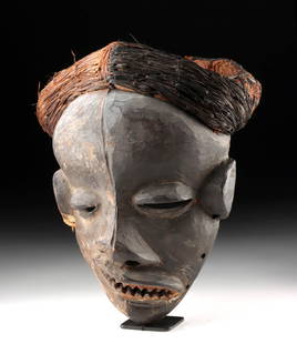 Pende Mbangu Mask - Twisted Face & Raffia Headdress: Central Africa, Democratic Republic of Congo, Pende people, ca. second quarter of the 20th century CE. A haunting embodiment of Pende belief and performance, this mbangu mask presents a powerful visua