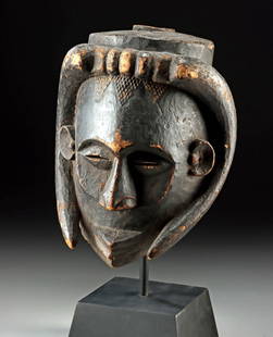 Early 20th C. Luba-Hemba Helmet Mask w/ Buffalo Horns: Central Africa, Zaire (Democratic Republic of Congo), Luba-Hemba people, ca. early 20th century CE. An imposing Luba-Hemba wood helmet mask, carved with serene and dignified facial features beneath an