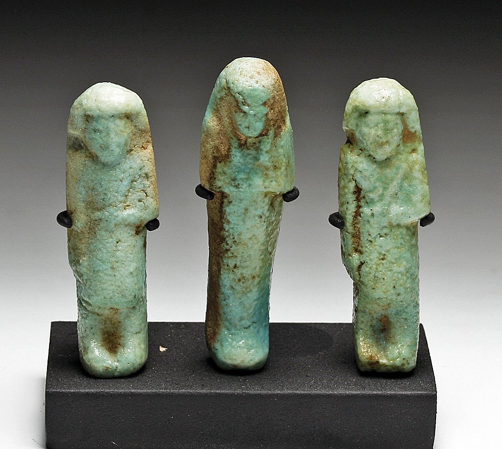 A Set of 3 Egyptian Faience Ushabtis: From ancient Egypt, Third Intermediate Period, Ca 1090 to 663 BC. Well-matched set of aqua-blue faience figures, comprised of two “foreman” type shabtis (oversaw work to be performed in the afterl