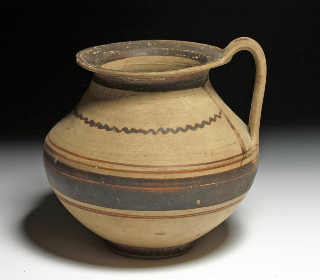 A Published Daunian Pottery Olpe: Southeastern Italy, Ca 4th century BCE. Another large and attractive Daunian pottery olpe uncovered in a Daunian tomb in 1944 by Byron Farwell, and later (1953) published in a book on his collection. 