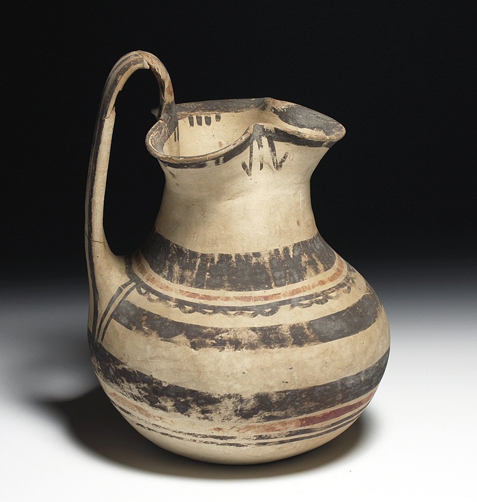 A Large Daunian Pottery Oinochoe: Southeastern Italy, Ca 4th century BCE. Large and elaborately decorated Daunian pottery oinochoe uncovered in a Daunian tomb in 1944 by Byron Farwell, and later (1953) published in a book on his colle