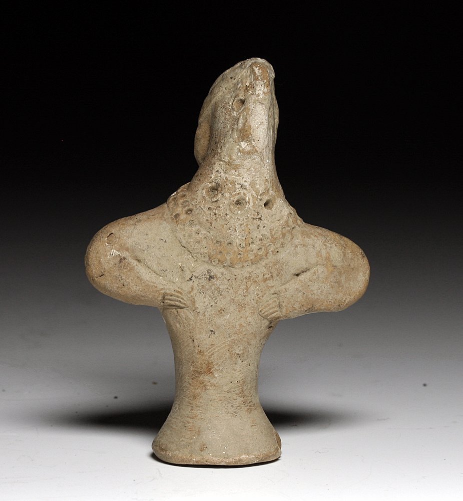 A Syro-Hittite Terracotta Figure: From the ancient Near East, Syria, Ca. 2000 BCE. Terracotta figure in abstract human form, with impressed detail of eyes, and jewelry. Remnants of white pigment. 3-1/4"H. Provenance: Ex D Smith Collec