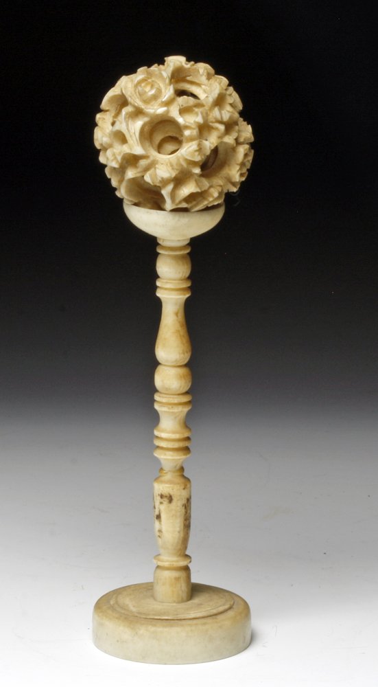 Antique Chinese Ivory Puzzle Ball and Stand: China, Ca. 1900. Antique ivory set, the multilayer ball pierced with writhing dragons and supported on a tall stand with wide base. 3-1/4"H. Provenance: Ex-Bishop Gallery, Allenspark, CO. Authenticity