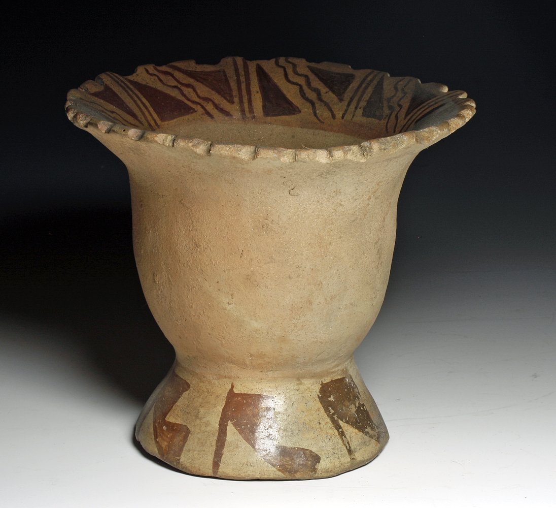 Pre-Columbian Moche Pottery Florero: From the Moche culture of northern Peru, ca 400 to 700 CE. In a form somewhat similar to a florero (called a Venus vessel), with broad base floral-shaped body and scalloped rim, decorated with red-bro
