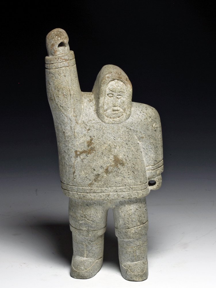 An Inuit Soapstone Statuette of Eskimo: Alaskan Territory, Ca. 1940 CE. Carved light colored soapstone statuette of Eskimo holding right arm in sky as if to harpoon a seal or whale. Lightly carved detail of clothing and face. Both hands hav