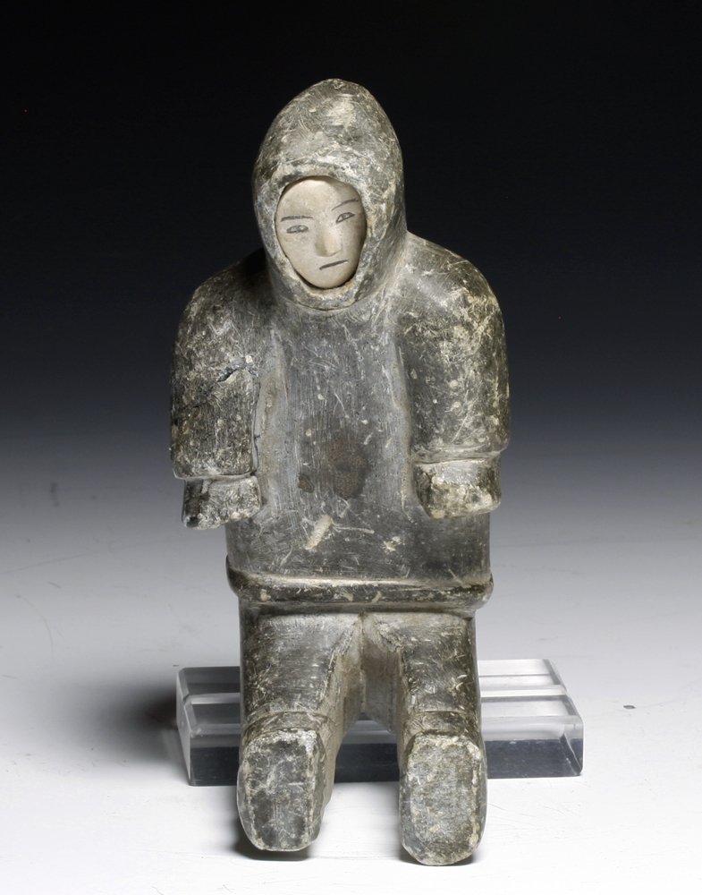 An Inuit Soapstone Statuette of a Seated Eskimo: Alaskan Territory, Ca. 1940 CE. A carved soapstone statuette of a seated Eskimo with added white face. 5"H. Provenance: Ex-Byron Farwell Collection. Authenticity Guaranteed The starting price is the p