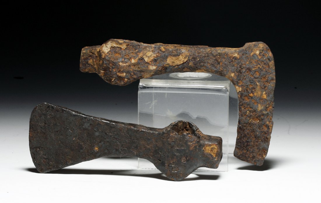 Pair of Byzantine to Medieval Iron Axe Heads: Ca 600 to 1200 CE. Pair of interesting iron axe heads, first of typical form with small hammer at rear, 2" blade at front. Other, more unique example again with hammer at end but long thin blade at ot