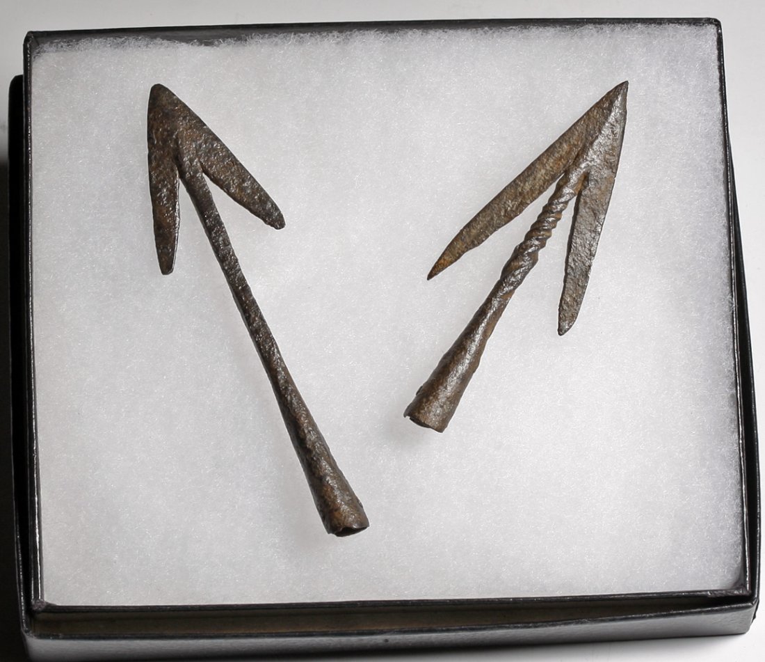 A Pair of Crusader Era Javelin Points: Byzantine Empire, Ca. 1000 - 1200 CE. Two iron javelin tips, with long tips that extend towards the base. One point has a beautifully twisted neck. 4-1/4"L and 3-1/2"L. Provenance: Ex Fort Knox Artifa
