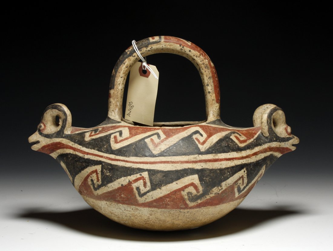 Large Casas Grandes, Ramos Polychrome Double Ram: Northern Mexico, Ca. 1250 AD - 1475 CE A large Casas vessel with the original handle present. This vessel has a rams head at each side of the vessel. Great colors with bold interlocking "Marriage"