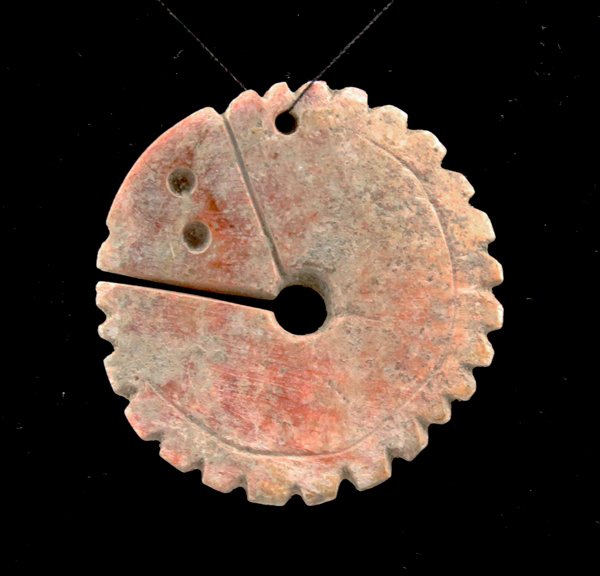 Rare Pre-Columbian Colima Carved Shell Pendant: A rare, large, round carved shell decorative pendant from the Pre-Columbian Colima region of ancient West Mexico, circa 200 B.C. - 200 A.D. This example measures approximately 1 3/4" in diameter (at w