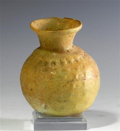 Islamic Glass Sprinkler Vessel: From the ancient Near East, ca. 1000 - 1200 CE. Golden green glass with bulbous body and everted rim; indented body and deeper indenting around neck. Dimpled bottom. 2-1/4"H. Provenance: Ex-private Ne