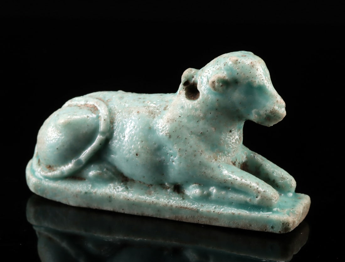Egyptian Faience Amulet - Hathor as Recumbent Cow: **Originally Listed At $350** Egypt, Late Dynastic to Ptolemaic period, ca. 664 to 30 BCE. An elegant faience amulet depicting the goddess Hathor as a recumbent cow. Fashioned from vibrant turquoise-b