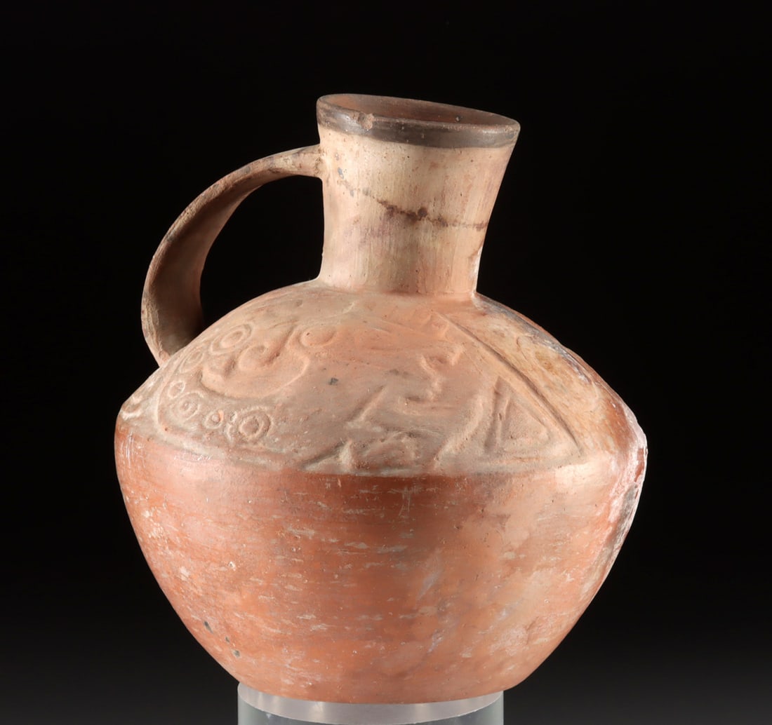Sican Pottery Jug w/ Double-Headed Jaguar Serpent: **Originally Listed At $300** Pre-Columbian, North Coast Peru, Sican/ Lambayeque, ca. 800 to 1100 CE. A lovely redware jar with a broad hip and a sloped shoulder adorned with relief imagery of a zoomo