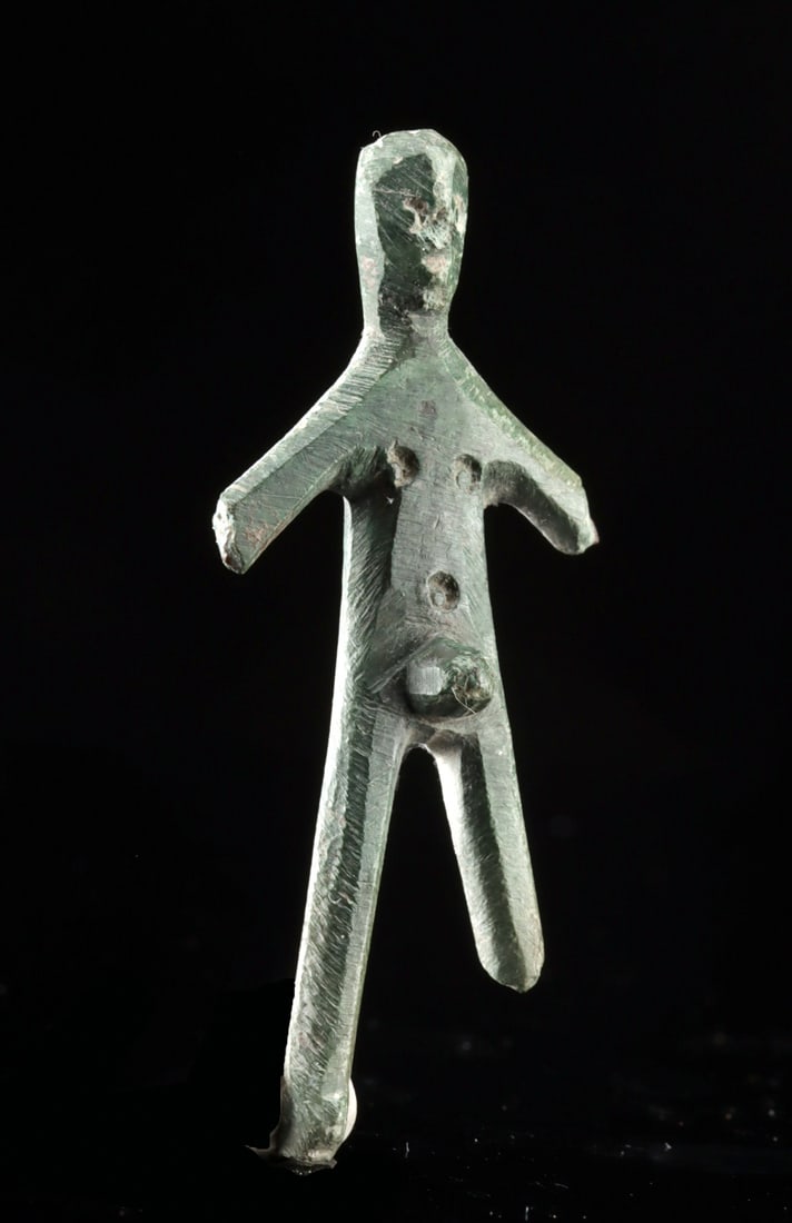 Italic Umbro-Sabellan Bronze Nude Male Worshipper: Ancient Italy, Umbro Sabellian Culture, ca. 5th century BCE. A rare and arresting vestige of Italic devotion, this schematic leaded bronze figure depicts a nude male worshipper standing in ritual pose