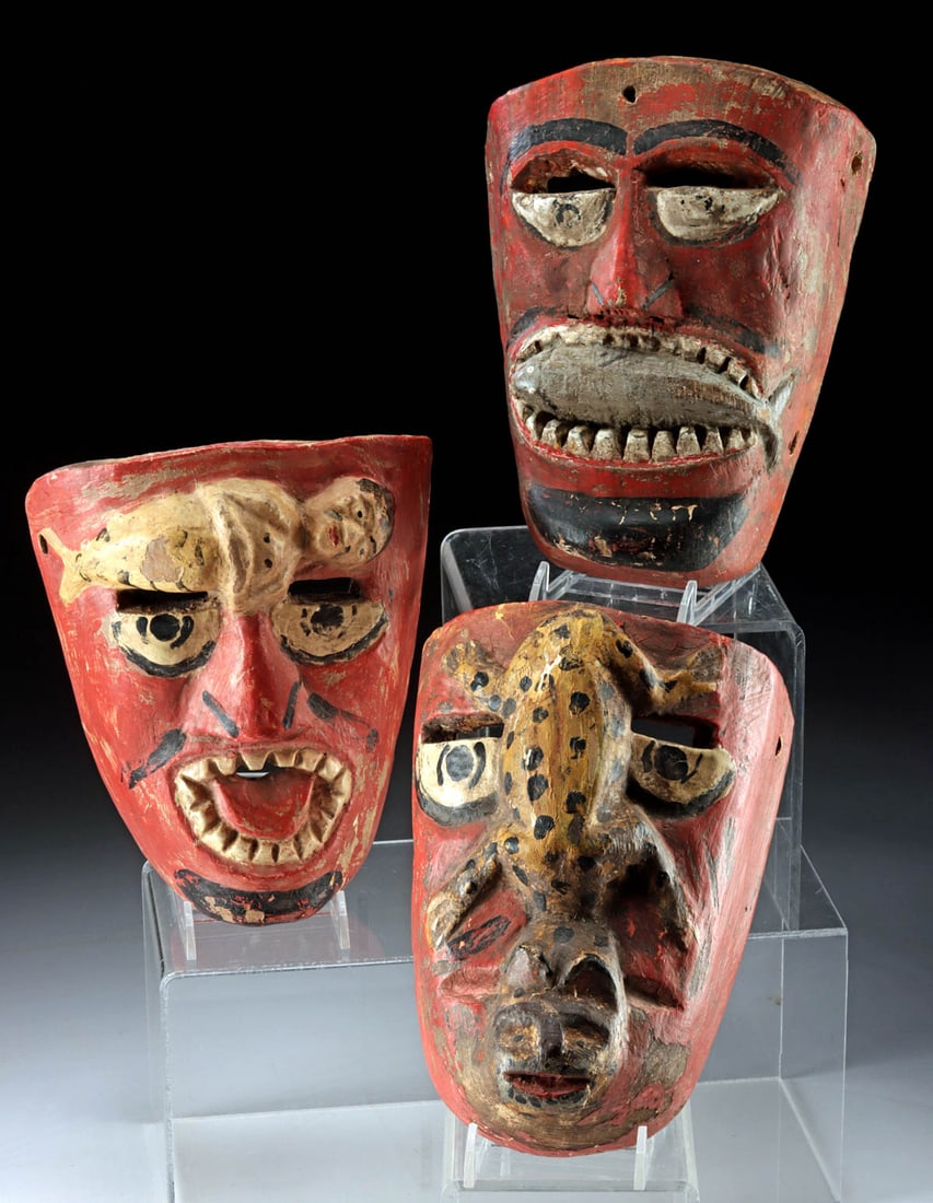 Guatemalan Painted Carnival Demon Masks (3): **Originally Listed At $300** Latin America, Guatemala, ca. early to mid-20th century CE. A dramatic trio of hand-carved wood demon masks from Guatemala, each painted a vibrant shade of scarlet with a