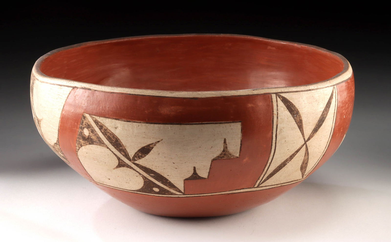 Large Early 20th C. Zia Pueblo Pottery Dough Bowl: Native American, Southwestern United States, New Mexico, Zia Pueblo, ca. early to mid-20th century CE. A large hand-built pottery dough bowl, its interior coated in a rich red slip glaze, while the ex