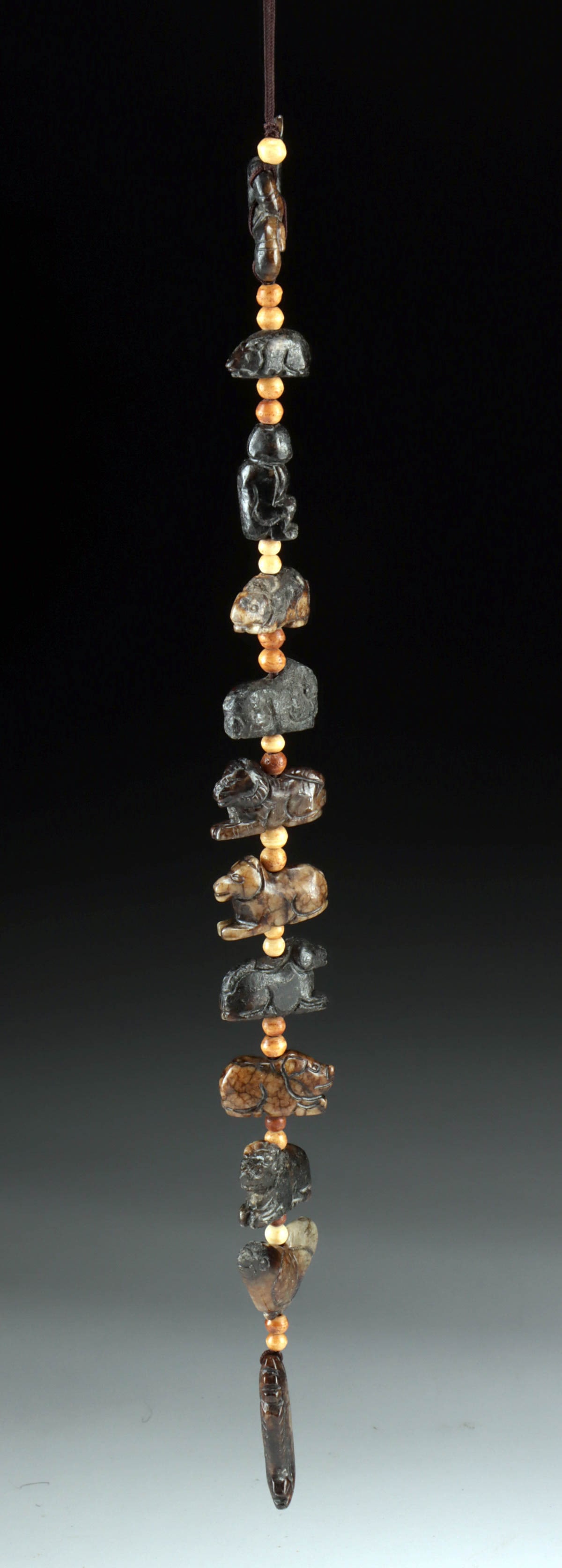 Chinese 12 Zodiac Animals Carved Stone Bead Strand: East Asia, China, ca. mid to late 20th century CE. A charming strand featuring twelve hand-carved stone pendants depicting the animals of the Chinese zodiac, each separated by small bone spacer beads