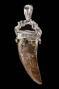 T-Rex Tooth Pendant in Silver Setting with Peridots: North America, Western United States, Late Cretaceous Period, ca. 69 to 66 million years ago. A striking pendant featuring a fossilized Tyrannosaurus rex tooth mounted in a custom silver setting. The