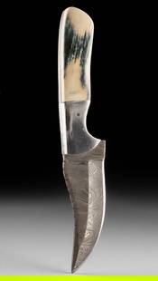 Custom Damascus Steel Knife w/ Fossilized Mammoth Ivory Handle: United States, ca. 21st century CE. A striking custom knife featuring a Damascus steel blade paired with a handle made from fossilized mammoth ivory, a material dating back thousands of years. The