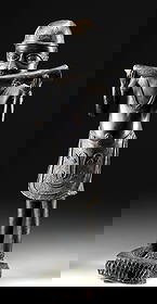 Tall Benin Brass Court Musician Playing Trumpet: West Africa, Kingdom of Benin (modern-day Nigeria), Edo culture, ca. 20th century CE. A commanding brass sculpture representing a court musician of the Benin Kingdom, shown mid-performance as he blows