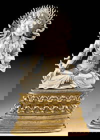 16th C. Ming / Qing Seated Guanyin, Bodhisattva of Mercy: East Asia, China, late Ming to early Qing, ca. 16th to 18th century CE. A serene and luminous figure of Guanyin, carved from lustrous ivory, seated gracefully upon a gilt brass base that gleams like a