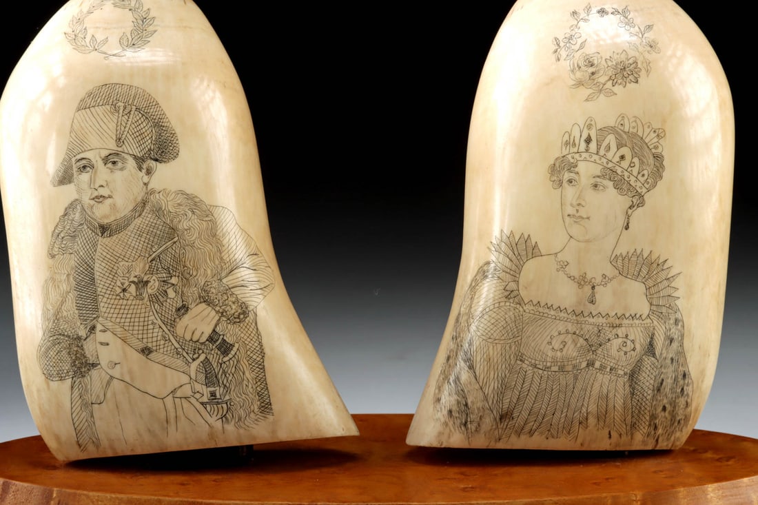 19th C. French Scrimshawed Sperm Whale Teeth - Napoleon & Josephine: Western Europe, France, ca. early 19th century CE. A superb pair of scrimshawed sperm whale teeth, each finely etched with neoclassical portraits of Napoleon Bonaparte and Empress Josephine. The Napol