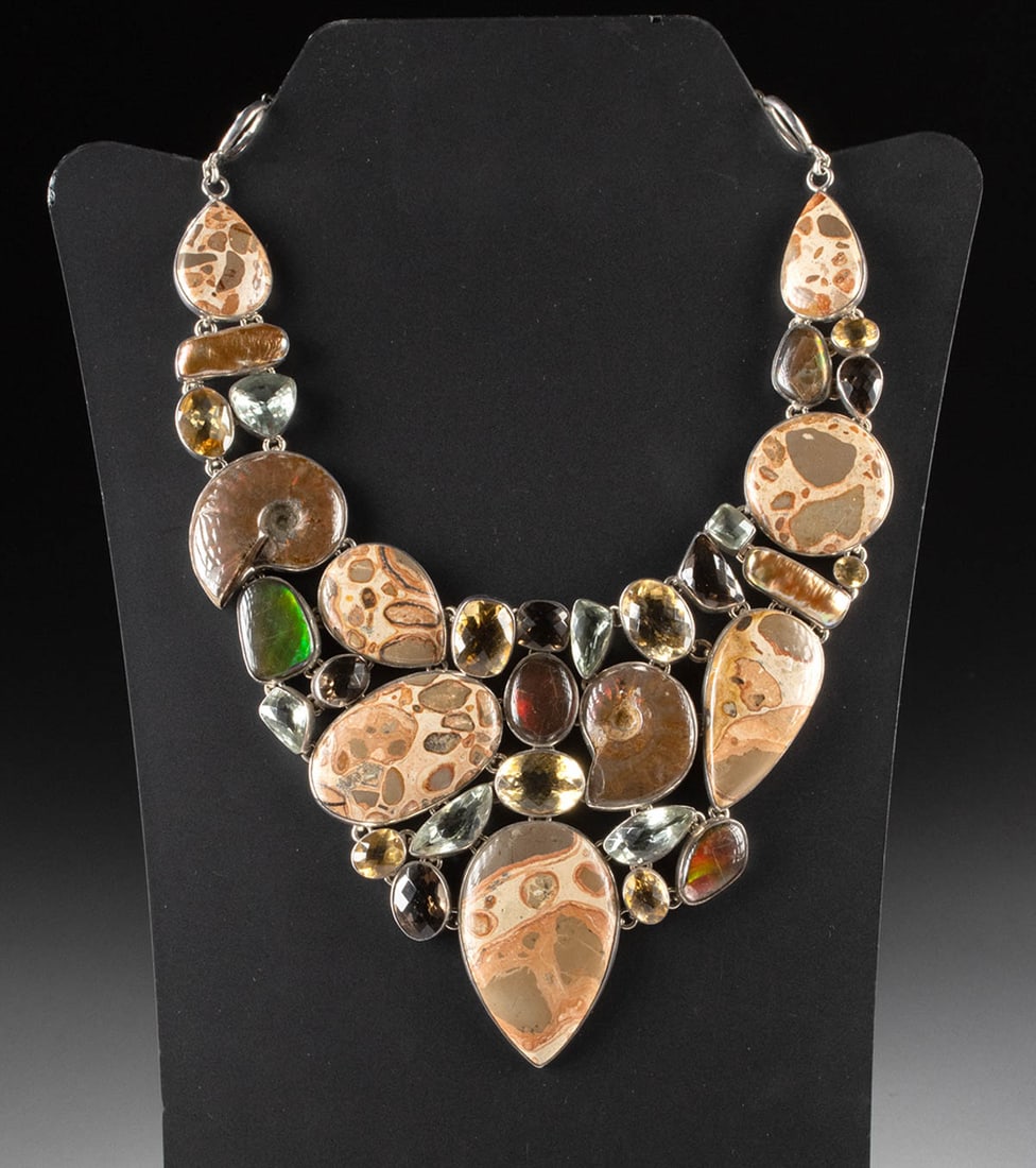 Ammonite Ammolite & Gemstone Silver Statement Necklace: United States, ca. 21st century CE. A striking and opulent statement necklace, crafted with an exquisite combination of natural gemstones and fossils. This piece features polished leopardite, faceted
