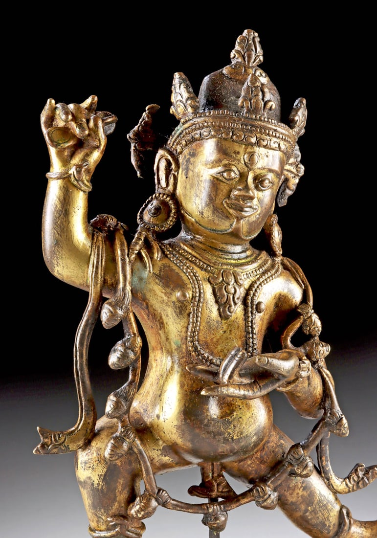 18th C. Tibetan Gilt Brass Vajrapani Figure: Central Asia, Tibet, ca. 18th century CE. A powerful gilt brass figure of Vajrapani, the thunderbolt-wielding protector and guide of the Buddha, depicted with three glaring eyes and a wrathful express