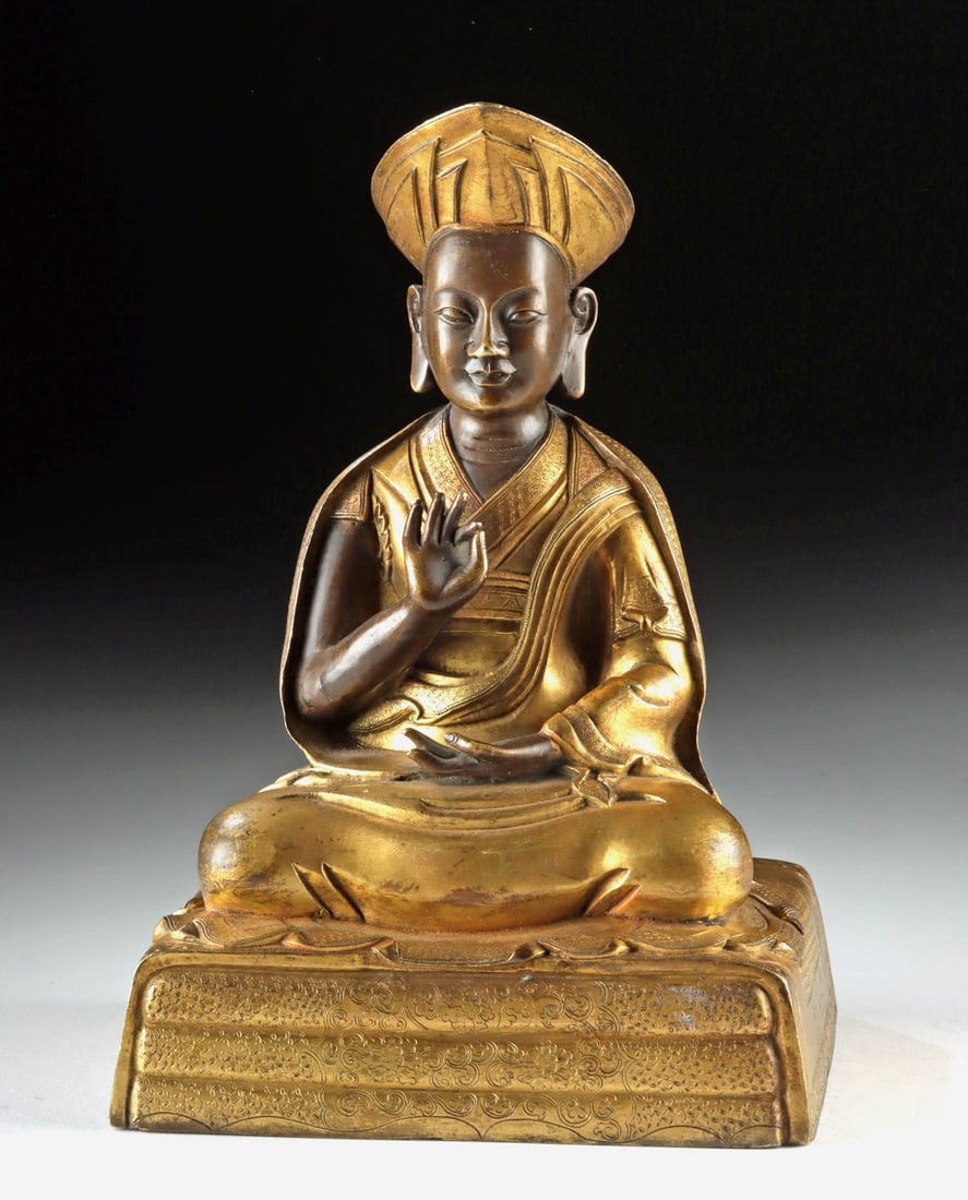18th C. Tibetan Gilt Brass Seated Lama - Rolpai Dorje: Central Asia, Tibet, ca. 18th to 19th century CE. A serene and finely cast Tibetan sculpture depicting a high lama, rendered in gilt brass with refined craftsmanship and quiet authority. The figure si