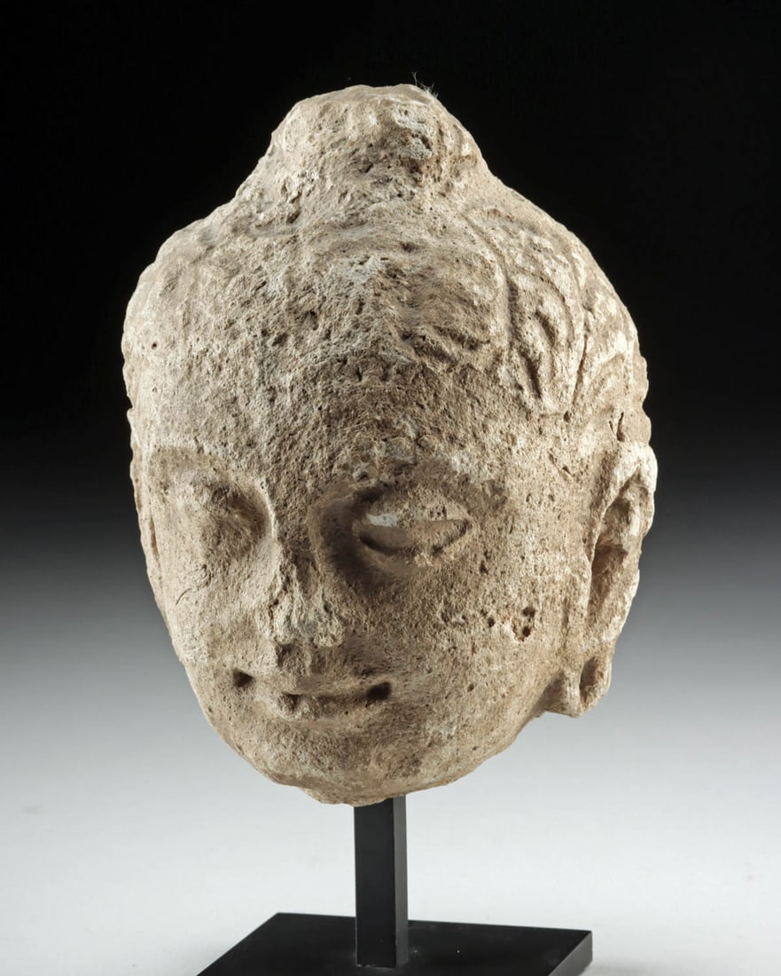 4th C. Gandharan Stucco Head of Buddha: Ancient Central Asia, Gandhara, ca. 4th century CE. A gentle, contemplative presence emerges from this Gandharan stucco head of the Buddha, its soft modeling and serene expression capturing the region