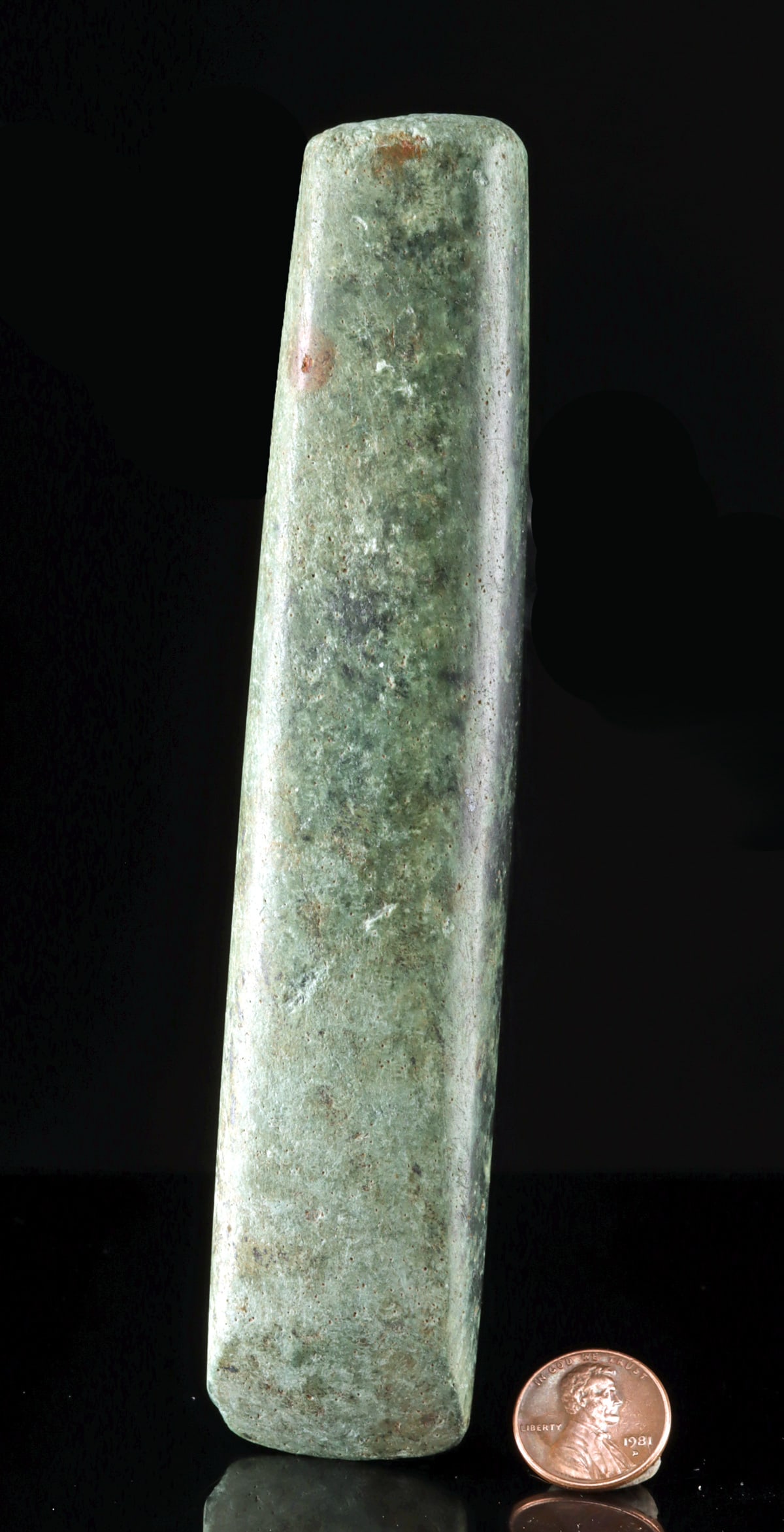 Maya Polished Greenstone Axe Head (Celt): Pre-Columbian, Honduras, Maya, Southern Maya Highlands, ca. 250 to 900 CE. A beautifully balanced greenstone axe head, its tapered form and cool, mottled surface carrying the quiet authority of an obj