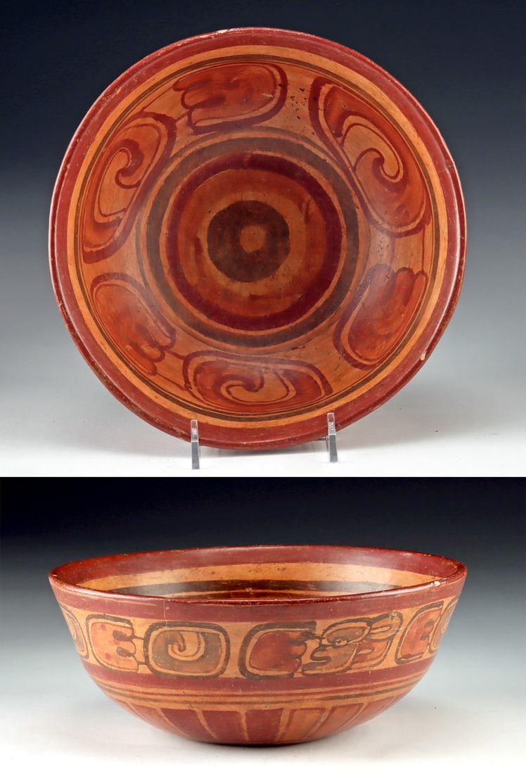 Maya Copador Bowl Glyphic Band Decoration: Pre-Columbian, Mesoamerica, Maya, Late Classic period, ca. 600 to 900 CE. A finely balanced Maya Copador pottery bowl whose warm red slip and rhythmic glyphic ornamentation create a visual cadence tha