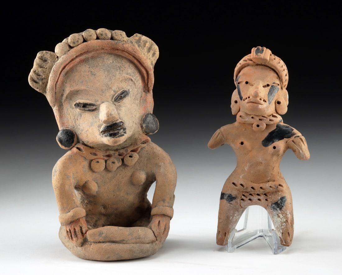 Veracruz Remojadas Terracotta Female Figures, Seated & Standing: Pre-Columbian, Gulf Coast of Mexico, Veracruz, Remojadas culture, ca. 3rd to 9th century CE. A pair of nude pottery female figures, accented with black bitumen pitch to emphasize facial features, jewe