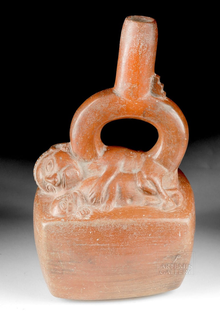 Sican Cuboid Stirrup Vessel w/ Erotic Figural Trio: Pre-Columbian, north coast of Peru, Sican/Lambayeque culture, ca. 750 to 1370 CE. A fascinating ceramic vessel, cuboid in form, with a stirrup handle and tall spout. Atop the vessel is an erotic trio