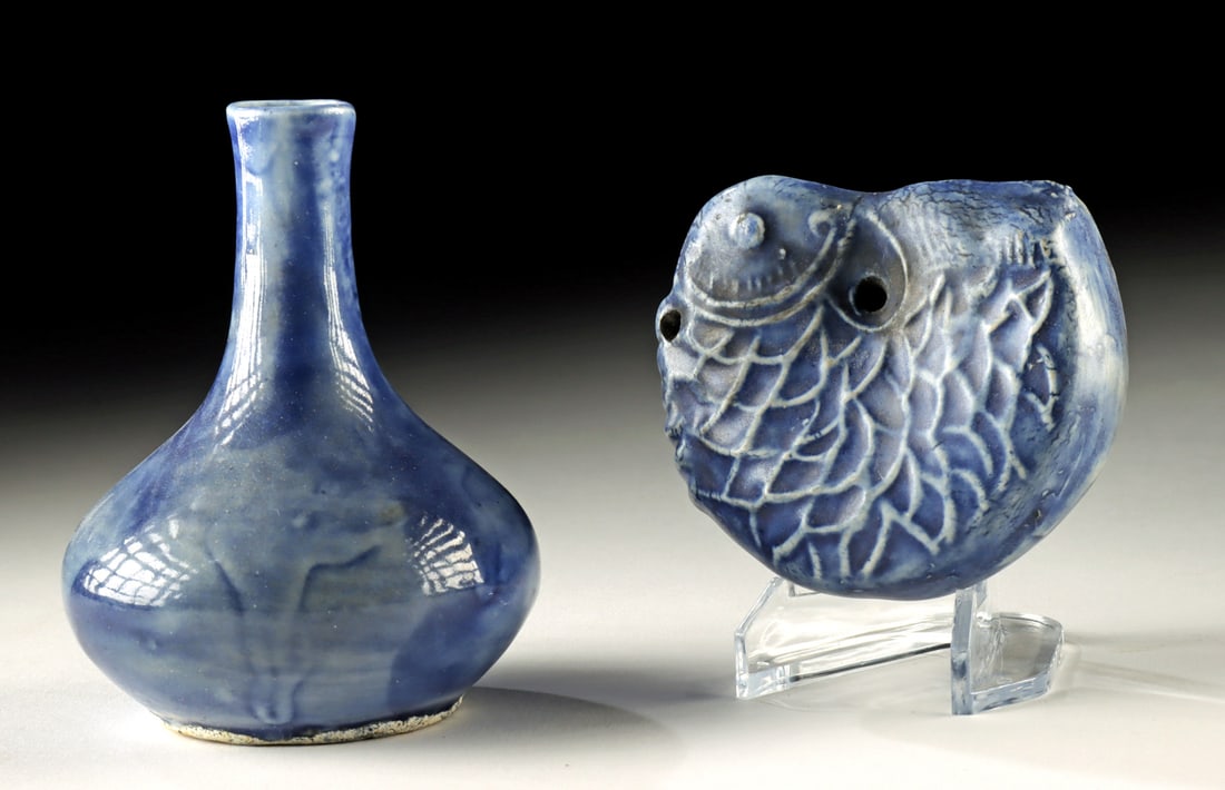 Korean Joseon Blue-Glazed Fish Water Dropper & Vase: East Asia, Korea, Joseon Dynasty, ca. 19th century CE. A charming pair of blue-glazed porcelain vessels from the late Joseon dynasty, comprising a fish-shaped water dropper and a bud vase, both showca