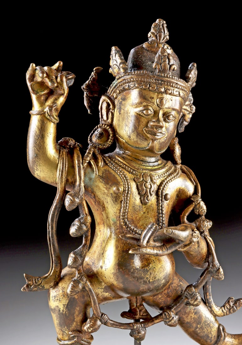 18th C. Tibetan Gilt Brass Vajrapani Figure: Central Asia, Tibet, ca. 18th century CE. A powerful gilt brass figure of Vajrapani, the thunderbolt-wielding protector and guide of the Buddha, depicted with three glaring eyes and a wrathful express