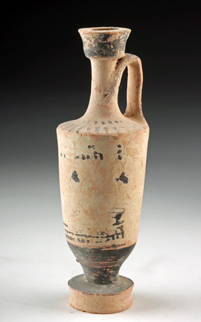 Greek Attic White Ground Pottery Lekythos: Greece, Attica, Classical period, ca. 5th century BCE. A slender and dignified Greek Attic white ground lekythos whose quiet elegance is inseparable from its role in ancient rituals of remembrance. Th