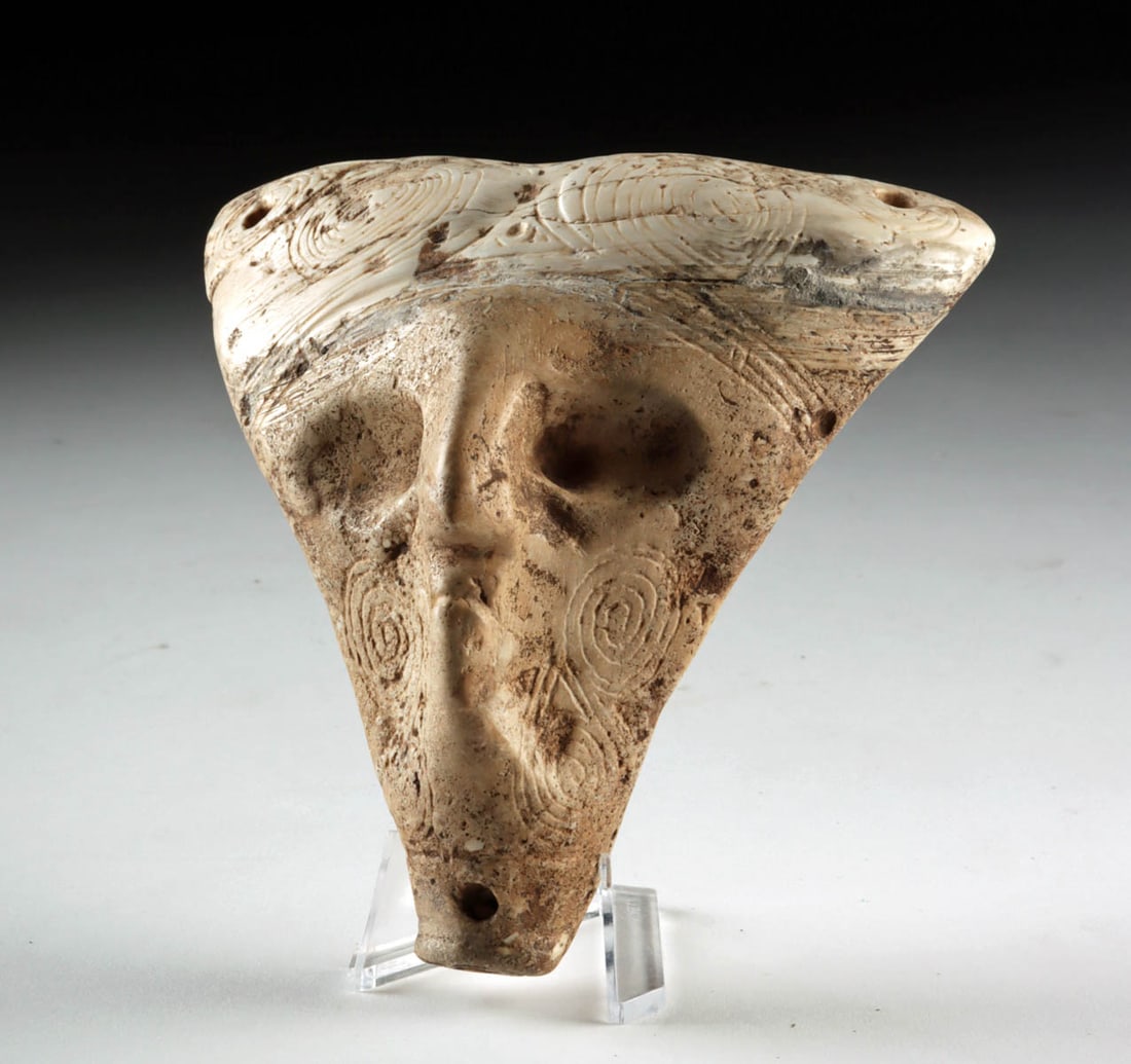 Taino Zemi-Style Shell Maskette Pendant, Ovoid Eyes: Pre-Columbian, Caribbean, Taino culture, ca. 900 to 1500 CE. A hauntingly expressive shell maskette pendant, carved with quiet authority and the watchful calm of the Taino spiritual world. Fashioned f