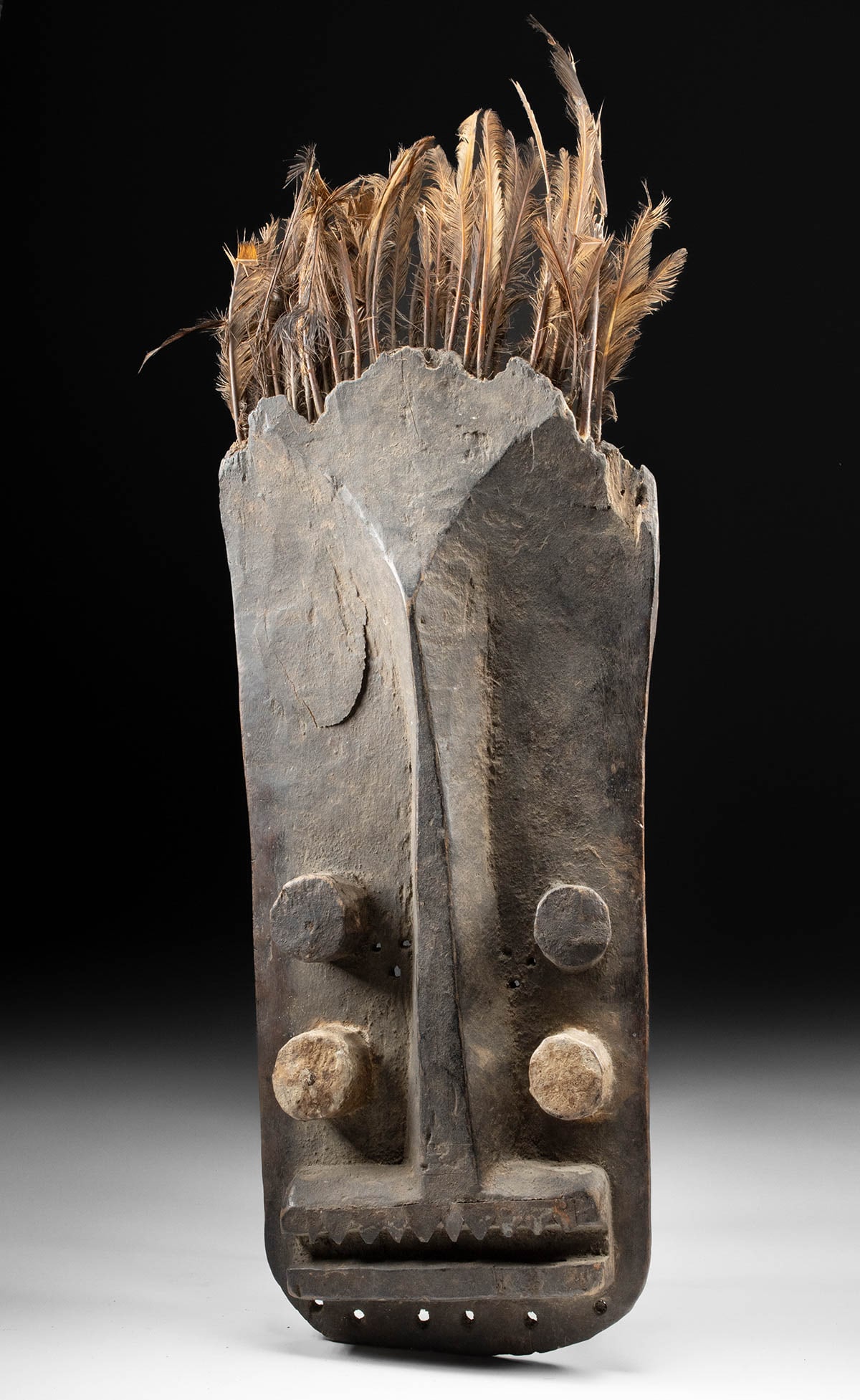 African Grebo Four-Eyed War / Spirit Mask Mask, Iron Jagged Teeth: West Africa, Liberia / Ivory Coast border region, Grebo people, ca. early to mid-20th century CE. A striking Grebo face mask carved from a single piece of dense wood, characterized by its bold geometr