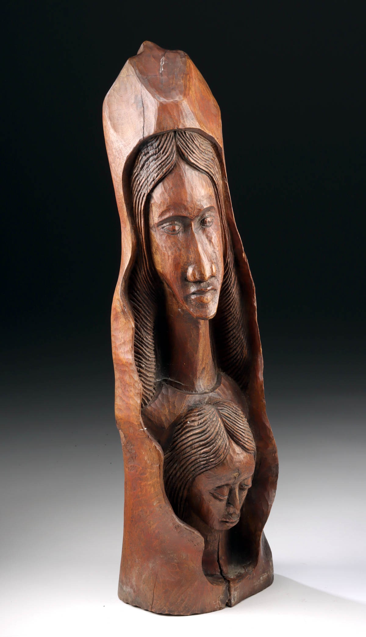 Ethiopia Christian Devotional Figure Mary Standing Over Praying Christ Child: Horn of Africa, Ethiopia, Christian Folk Art, ca. 20th century CE. A carved wood devotional sculpture depicting the Virgin Mary standing above the Christ Child, this striking Ethiopian folk art work p