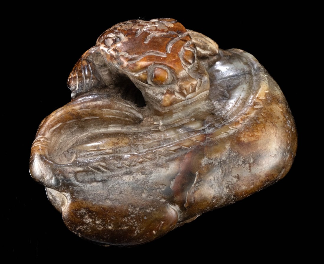Chinese Ming Dynasty Khotan Jade Coiled Mythical Beast: East Asia, China, Qing Dynasty, ca. 19th century CE. A lovely mutton jade (nephrite) carving of a mythical beast resembling a coiled, recumbent tiger. Boasting natural hues of caramel and mocha, the l