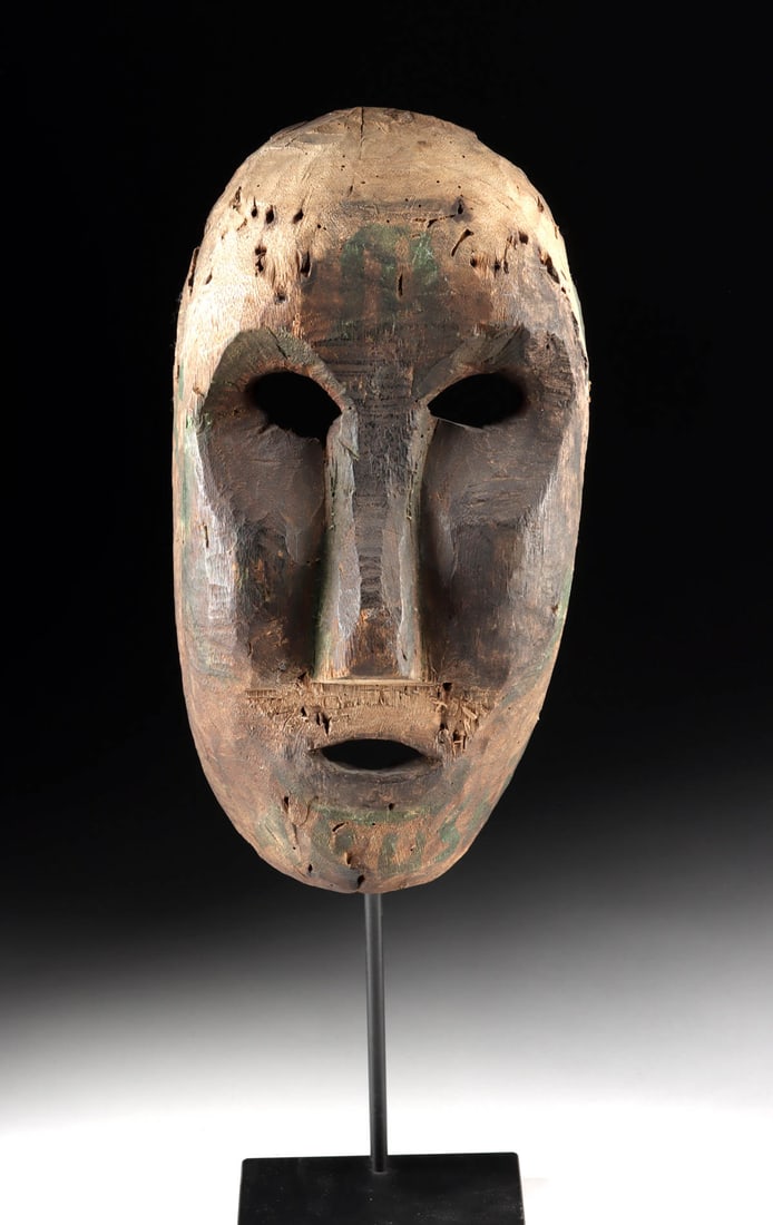 19th C. Nepalese Wood Shaman Mask w/ Trace Pigment: Central Asia, Nepal, Western or Middle Hills region, ca. late 19th to mid-20th century CE. A weathered spirit rises from this Western Nepalese shaman mask, its hollow eyes and sharp, planar features p