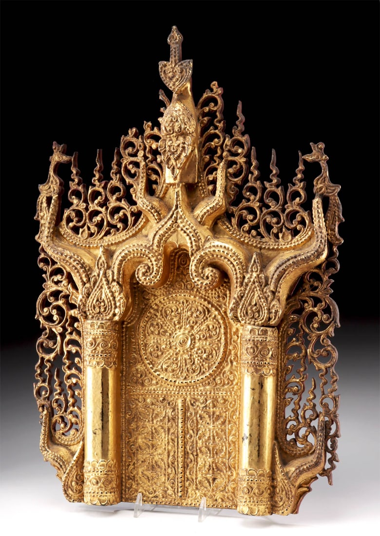 19th C. Burmese Gilt Wood Buddha Throne - Back Panel: Southeast Asia, Burma, ca. 19th century CE. An ornate and masterfully crafted gilt wood throne back panel, once forming the radiant backdrop to a seated Buddha image. Fashioned in the traditional Burm