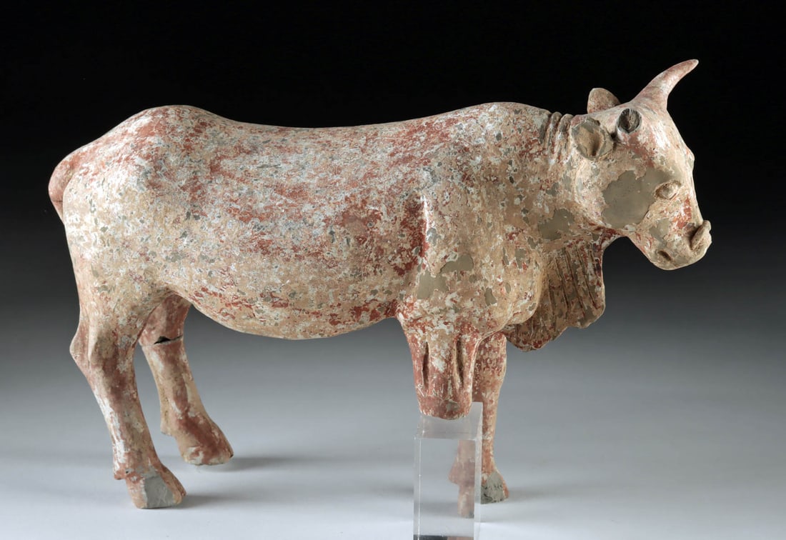 Chinese Han Dynasty Painted Pottery Bull Tomb Mingqi: East Asia, China, Han Dynasty, ca. 206 BCE to 220 CE. A hollow earthenware bull/ox modeled in a standing pose with a short tail, and alert head crowned by forward-curving horns. The surface was probab