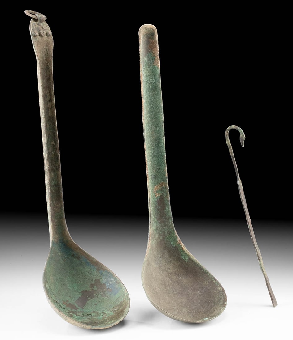 Ancient Bronze Chinese Han Ladles & Roman Spatula: East Asia, China, Han Dynasty, ca. 206 BCE to 220 CE; Roman Empire, ca. 2nd century BCE to 2nd century CE. A fine trio of ancient bronze utilitarian implements, including two Chinese ladles and one Ro
