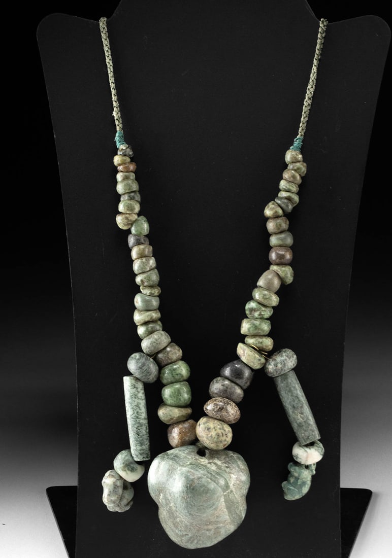 Impressive Mesoamerican / Maya Greenstone Bead Necklace: Pre-Columbian, Southern Mexico, Guerrero region, Mezcala to early Maya culture, ca. 600 BCE to 100 BCE. A necklace composed of mottled greenstone and possibly jadeite beads strung to showcase a broad
