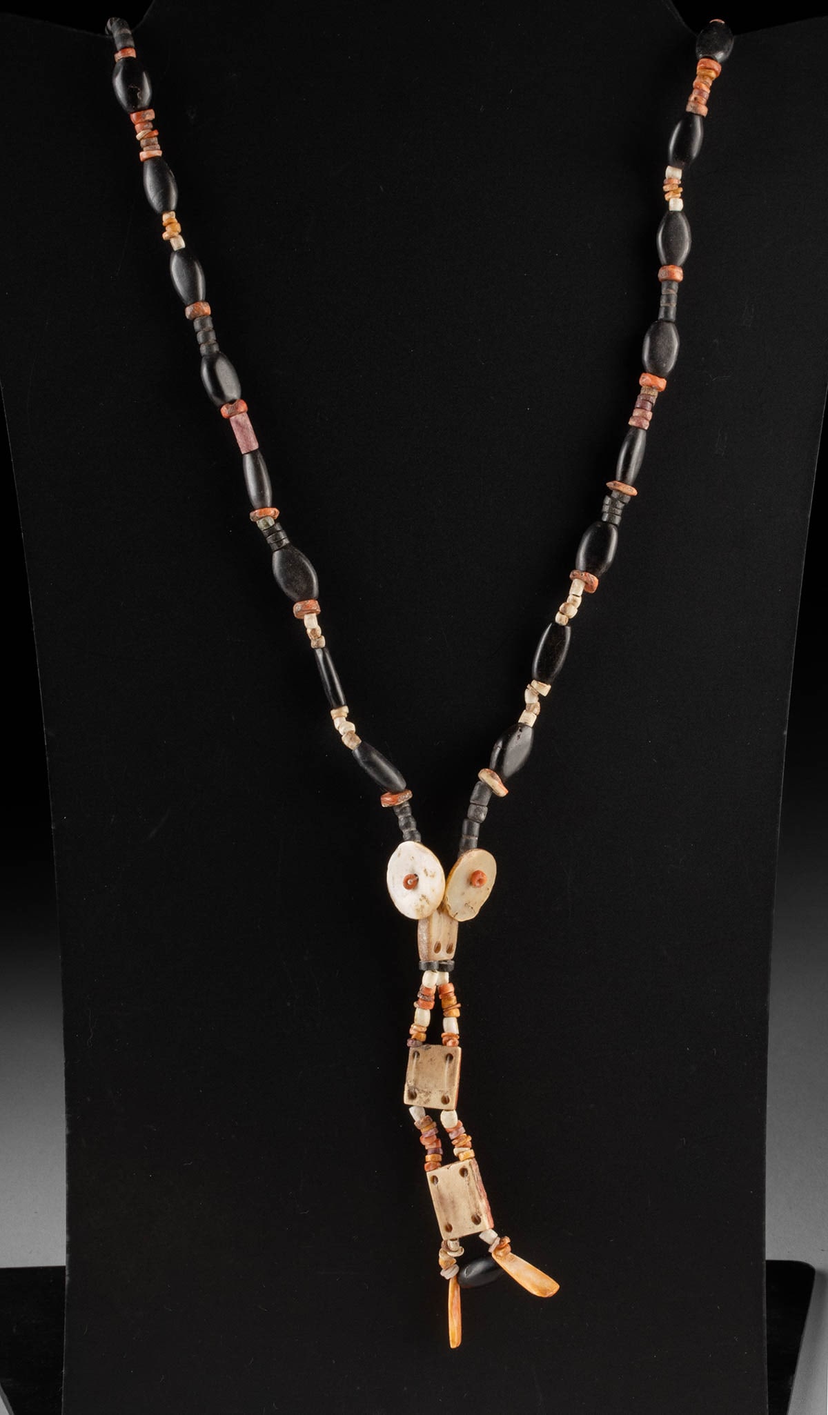 Pre-Columbian Bead Necklace, Spondylus Shells & Nacre: Pre-Columbian, Peru, Nazca-Inca culture, ca. 100 to 1470 CE. An assembled strand of ancient beads restrung in modern times as a wearable necklace, combining elongated black stone beads with orange-red
