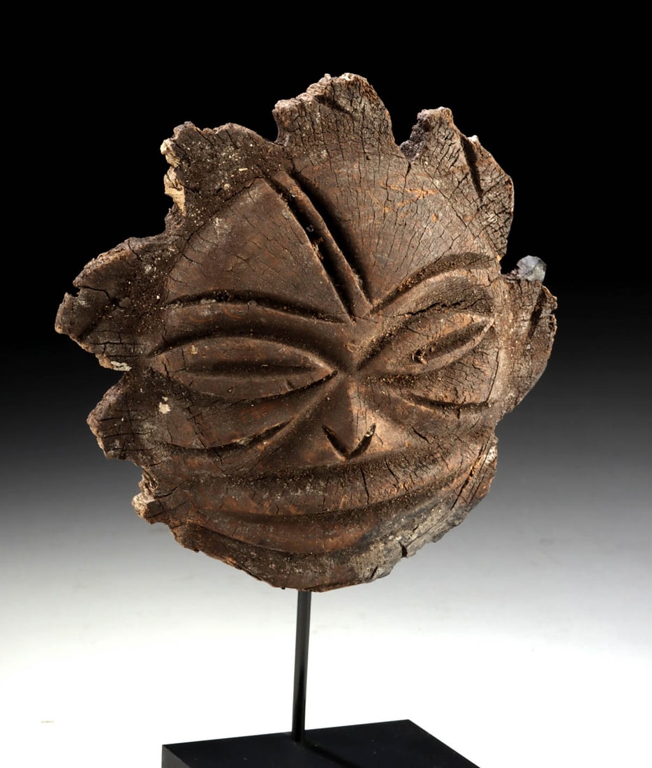 DRC Congo Lega Carved Wood Stylized Face Ornament: Central Africa, Democratic Republic of the Congo, Lega peoples, ca. 19th to early 20th century CE. A dense wood carving presenting a stylized anthropomorphic face with elongated, lidded eyes, a simpli